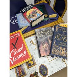 Eleven JK Rowling books, comprising six Harry Potter books, including four first editions, Fantastic Beasts screen play, Harry Potter and the Cursed Child, Tales of Beedle the Bard, Casual Vacancy first edition, Christmas Pig First edition and a Harry Potter card board back drop