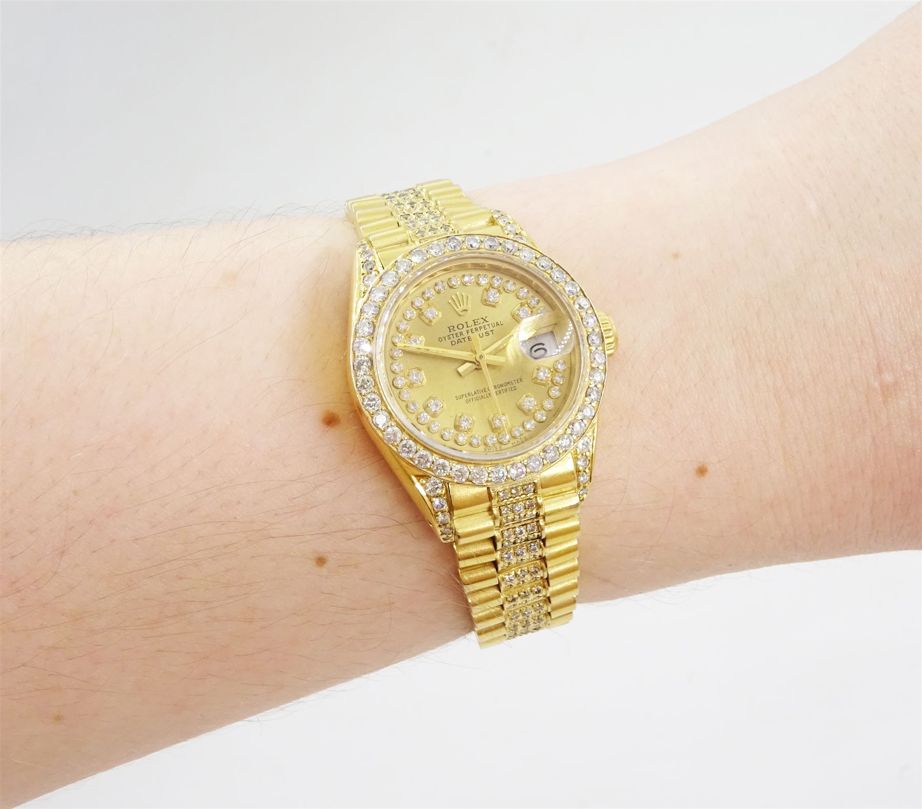 Rolex Oyster Perpetual Datejust ladies 18ct gold automatic wristwatch, circa 1983, Ref. 69178, serial No. 8058240, champagne dial diamond dot hour markers and outer diamond ring, after market diamond set bezel and lugs, on 18ct gold President bracelet, set with after market diamonds, with AIGL report and additional links