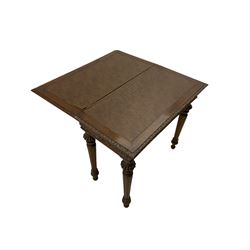 Victorian carved oak card table, fold-over top with lunette carved edge mould, the top swivels to reveal storage well, the frieze carved with scrolled foliate, on turned and fluted supports