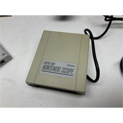 Two Super Nintendo Entertainment System (PAL) controllers, accessories and games. Super NES Game Commander with original box and instruction booklet, Super NES Nintendo Scope (1992) transmitter gun, receiver, Super NES Nintendo Scope 6 game with original instruction booklets. Further games to include ‘The Legend of Zelda a Link to the Past’, ‘Super Mario World’, ‘Super Mario Kart’, ‘The Lawnmower Man’, and ‘Exhaust Heat’, all with original instruction booklets. ‘PowerMonger’ and Disney’s ‘Aladdin’ game cartridges only 