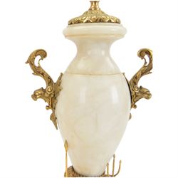 Onyx table lamp, of urn form with scrolling gilt handles, the stepped circular base adorned with three seated putti, H60cm