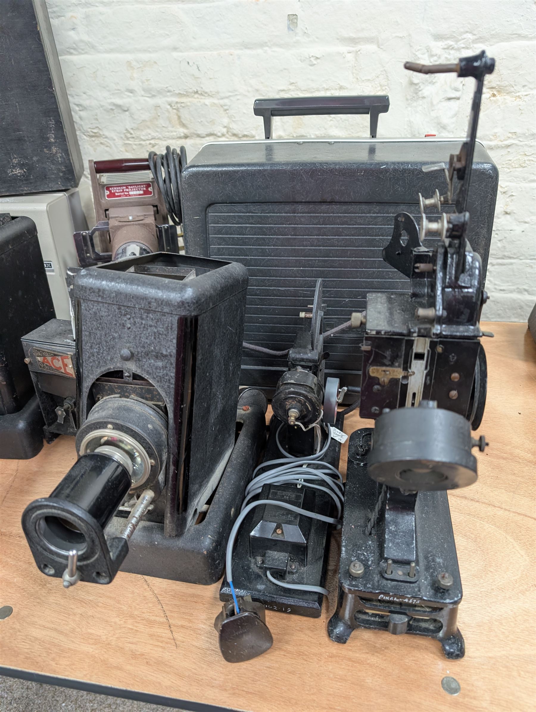 Ten vintage projectors, including Bell & Howell 1623x, Kershaw Daylight Strip projector, Aldis, Leitz, Pathoscope Ace, Ray Safety Cinema, Baby Projector and Pullin Optics