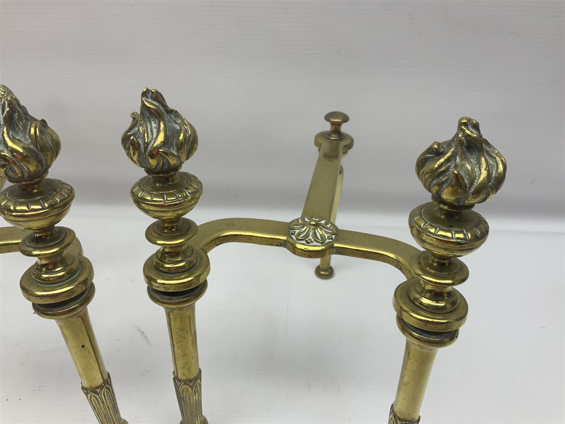 Early 20th century brass coal bucket with pierced sides, upon three pad feet, together with a pair of brass fire dogs, with flambe finials, coal bucket H27cm