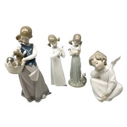 Four Lladro figures, comprising Girl with Puppies no. 1311, Angel Dreaming no.4961, Don't Forget Me no.5743 and Girl with Guitar no.4871