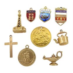 Six 9ct gold charms including kettle, Blackpool tower, lamp, cross, two enamel place name charms, 18ct enamel charm and an Edward VII 1902 gold half sovereign coin