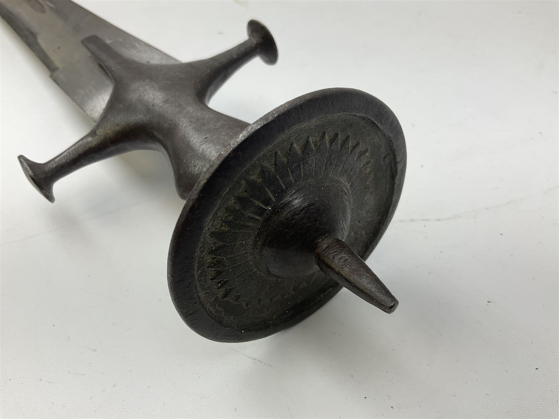 19th Century Indian Tulwar sword with 77cm single edged, slightly curved fullered blade;  steel crossguard, langets, grip and spiked disc pommel with stiff leaf decoration L90cm overall