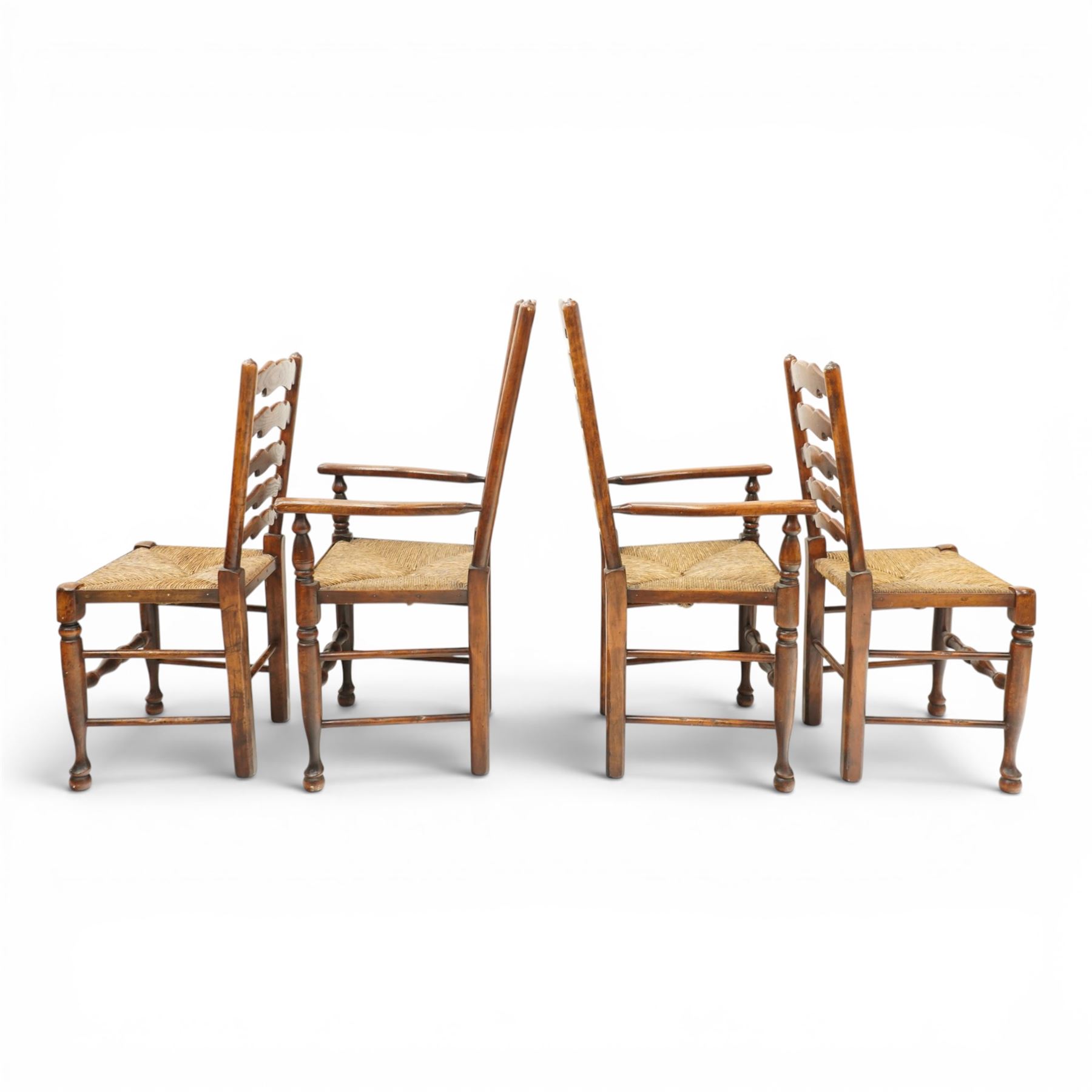 Set of eight country ladderback chairs (6+2), shaped ladderback over a rush seat, raised on turned supports, united by stretchers