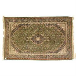 Central Persian Kashan rug, emerald green ground, with a central ivory, indigo, and brick ...