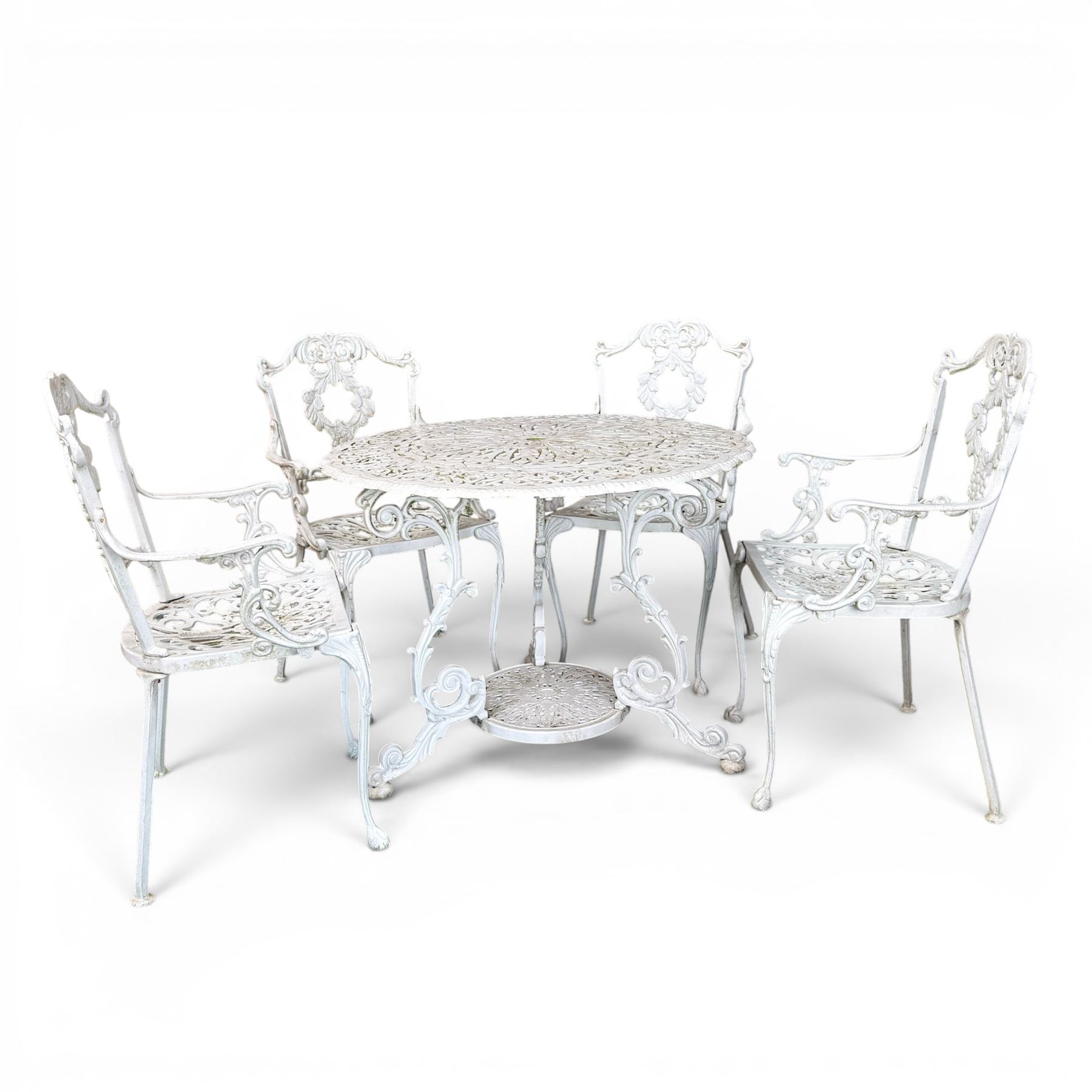 Victorian design cast aluminium circular garden table and four armchairs, ornate grape design in antique white paint
