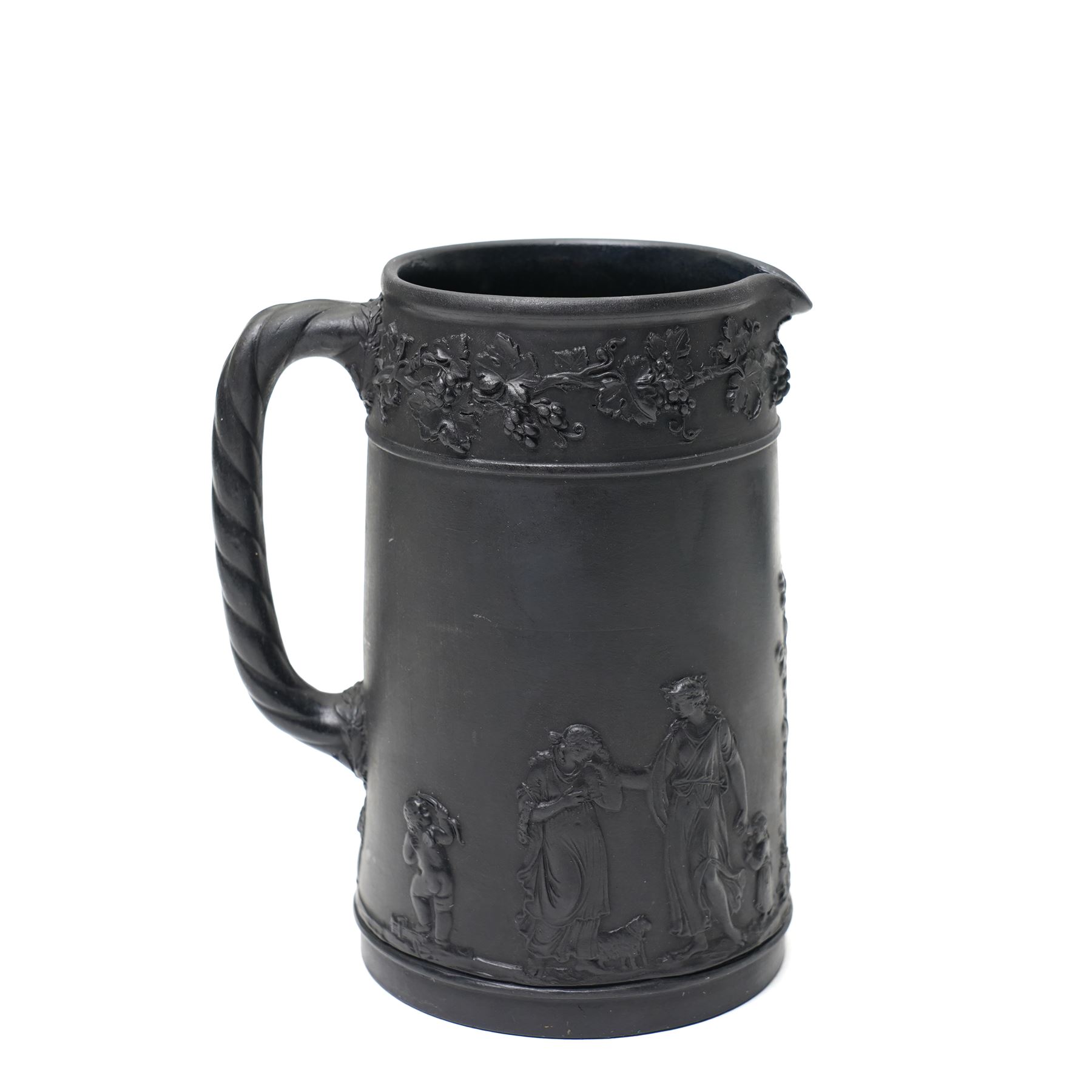 Four pieces of 19th century Wedgwood black basalt ware, c.1875, comprising larger and smaller jug, covered sucrier and teapot, each decorated with classical scenes in high relief, larger jug H13cm