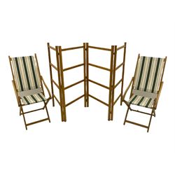 Two folding beech framed garden chairs with slung striped covers and a folding pine clothes horse 