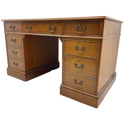 Cherrywood twin pedestal desk, rectangular leather inset top over central fall front with keyboard slide and two drawers, fitted with two drawers and cupboard, on bracket feet