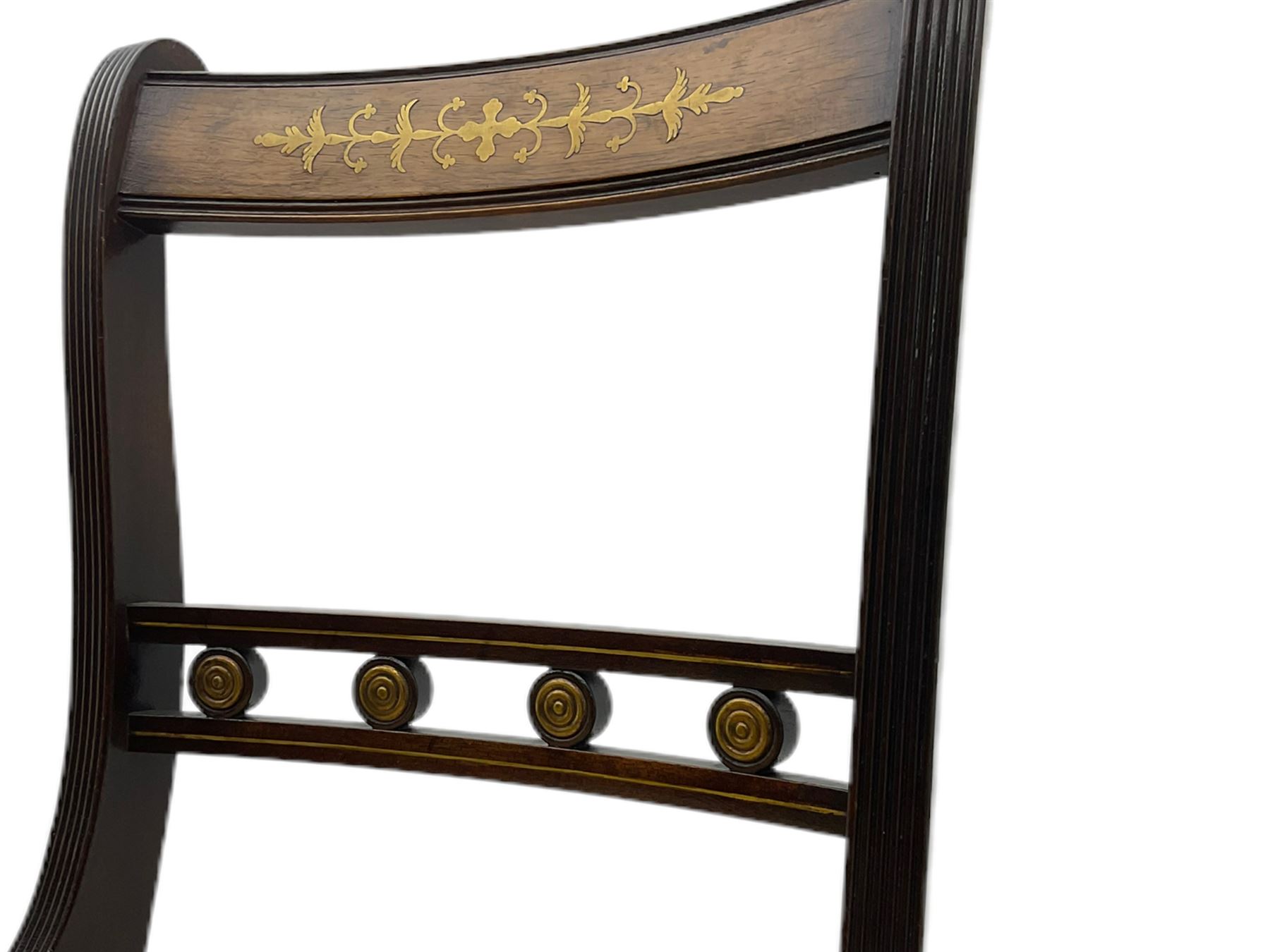 Set of eight Regency style mahogany dining chairs, brass inlay with gilded detail