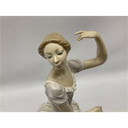Four Lladro figures, comprising an example modelled as a ballerina dancer seated upon a stool, a further figure modelled as a female stood in wind with a basket of flowers at her feet and book behind her back, and two other examples modelled as young girl with lamb and girl with lilies, tallest H35.4cm
