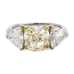  Platinum three stone diamond ring, the centre fancy light yellow cushion cut diamond of approx 1.70 carat with two white trillion cut diamonds either side, each weighing approx 0.60 carat, hallmarked, total carat weight approx 2.90 carat  