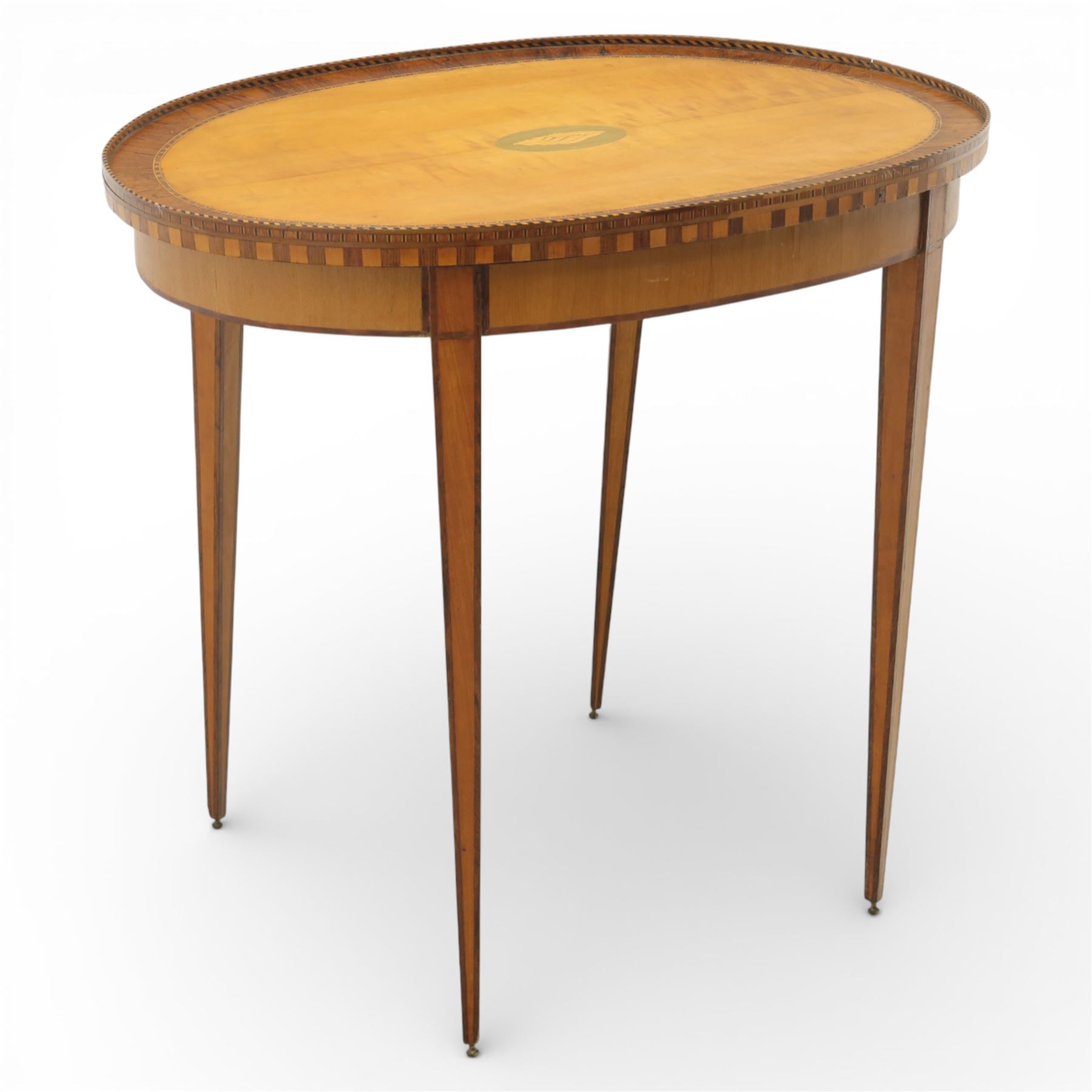 Early 19th century Sheraton revival satinwood oval table, shell motif to the centre bordered by walnut veneer, with inlaid banding, supported on square tapering legs terminating in brass feet