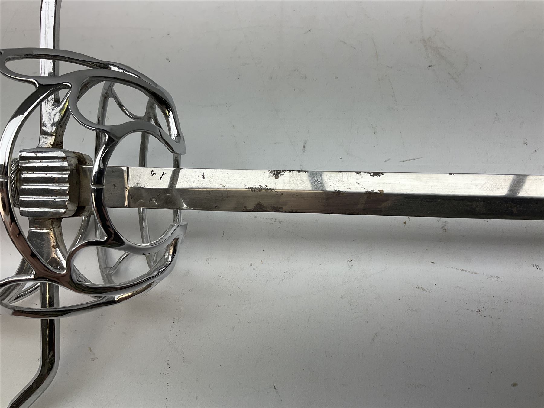 Replica knight's longsword, the 91.5cm double-edged steel blade with basket hilt and wire-bound bone grip with spherical pommel, in leather scabbard L112cm overall