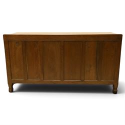 Mouseman - adzed oak kneehole dressing table or desk, the rectangular adzed top with raised back and canted corners, over an arched recessed kneehole flanked by three graduating drawers to each side with turned knob handles, raised on octagonal feet, with carved mouse signature, by the workshop of Robert Thompson of Kilburn