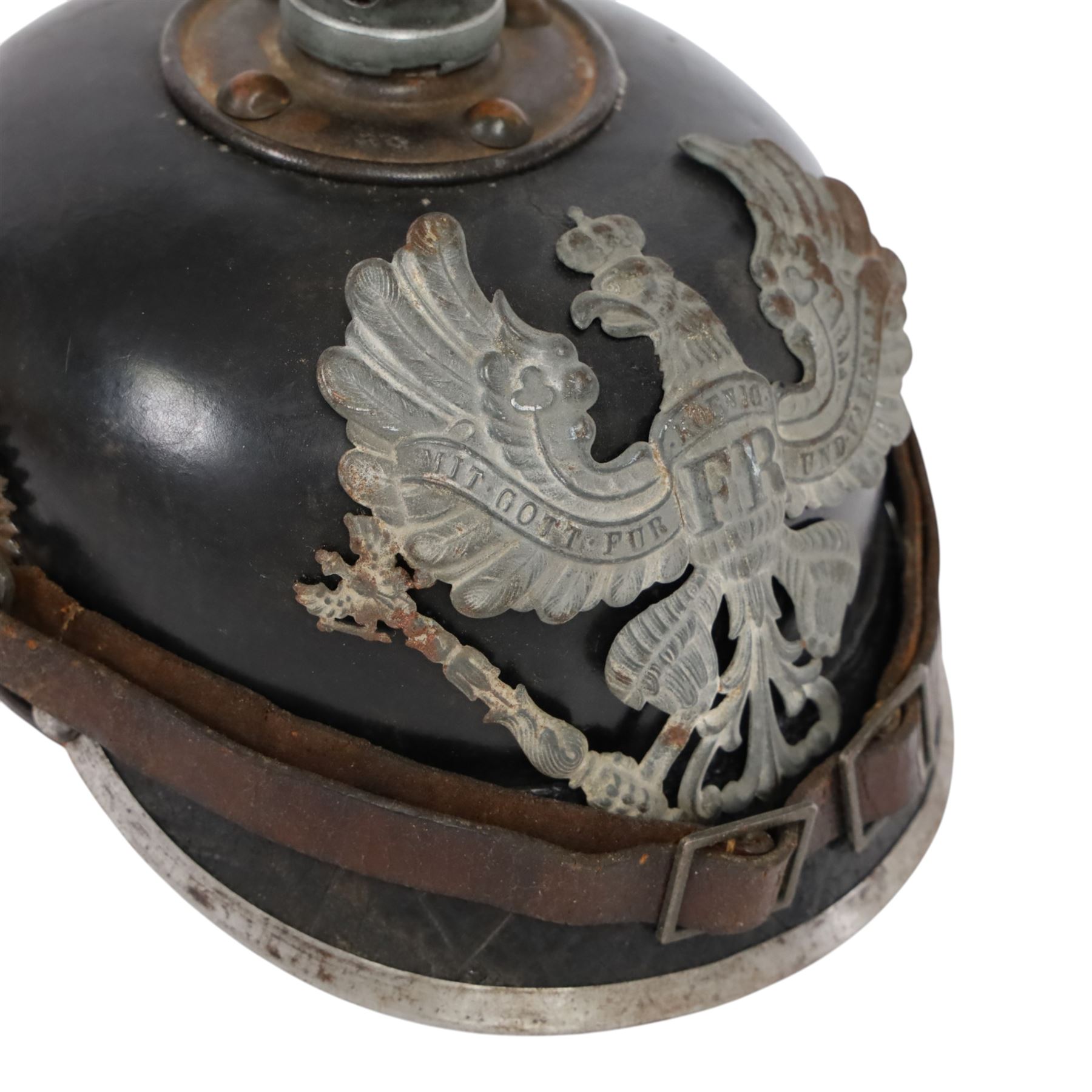 WWI Prussian M1915 Pickelhaube, the black leather skull with removable steel spike finial, steel eagle helmet plate and leather chin strap, one side with a black cockade, the other black and red