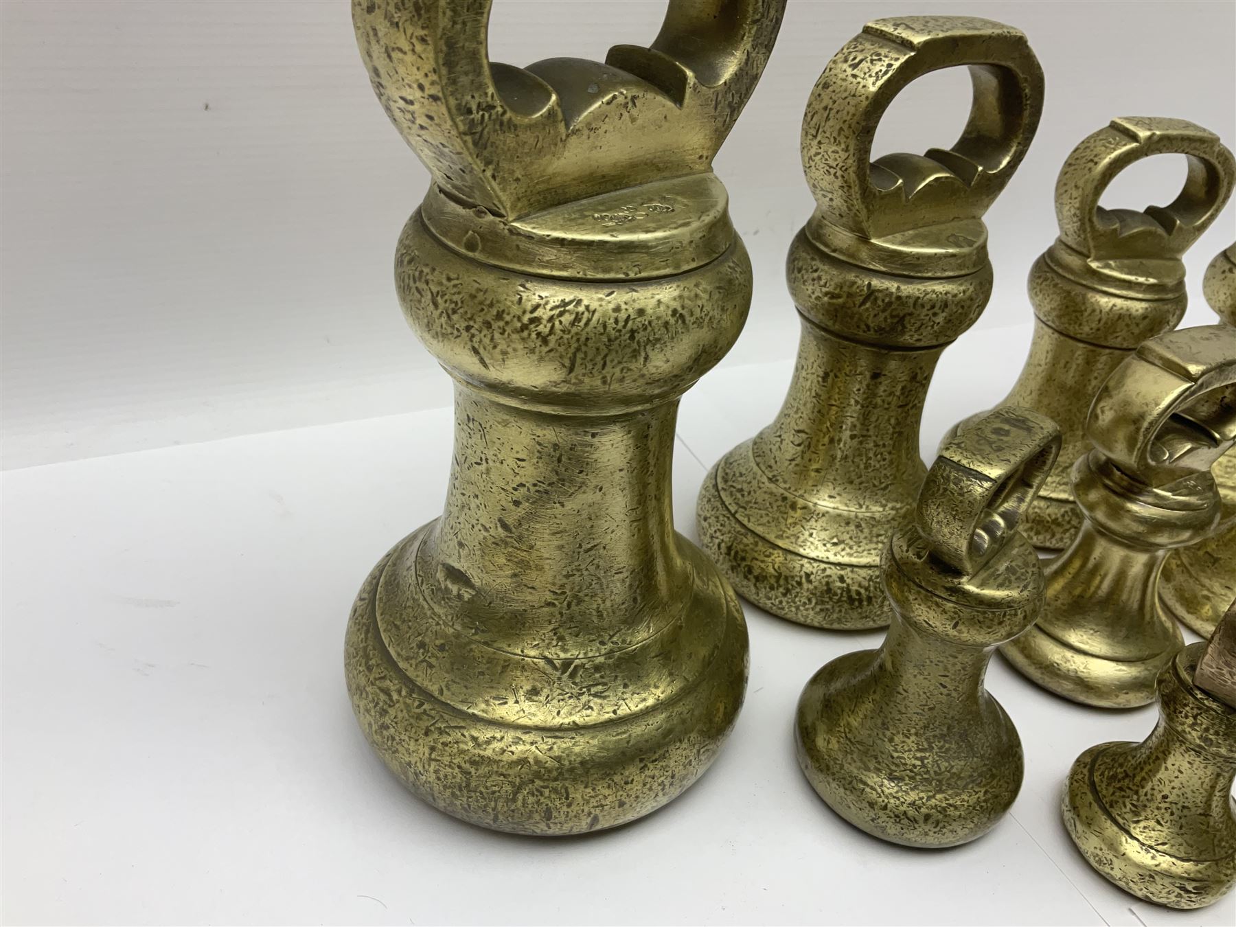Set of seventeen Victorian brass bell weights