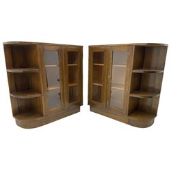 Pair of mid-20th century oak bookcases, rectangular form with curved ends, enclosed by glazed doors and fitted with shelves
