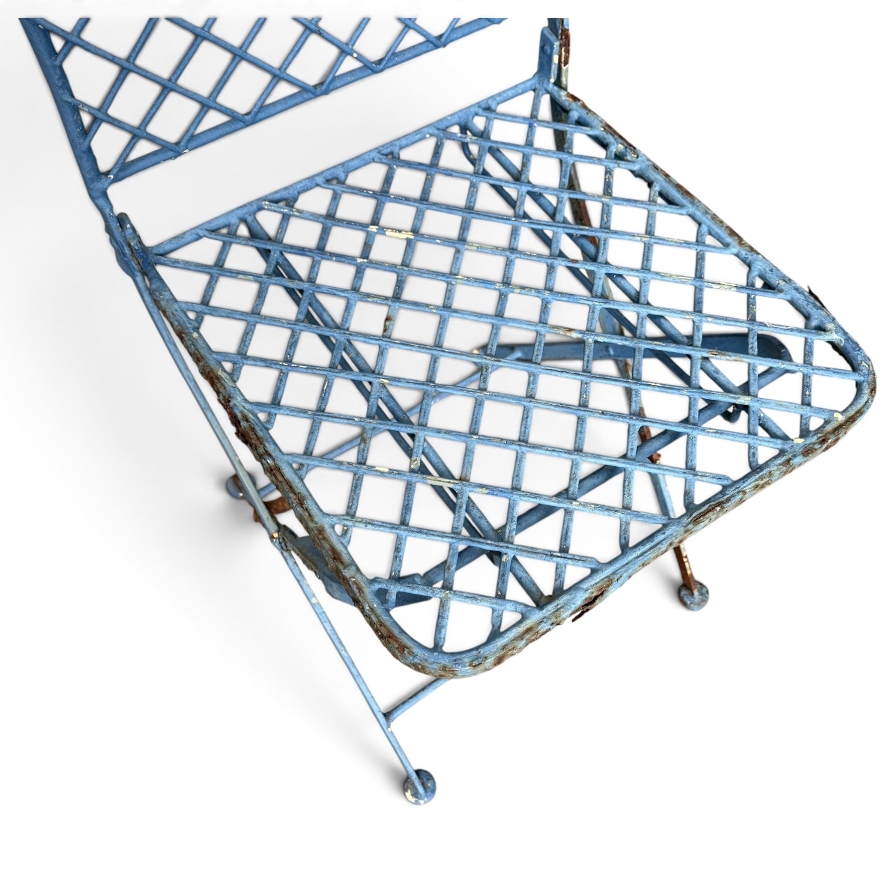 Three-piece French style blue-painted wrought iron garden bistro set, comprising a circular folding table with latticework top and central fruiting grapevine medallion (W71cm H76cm) and matching pair of chairs, with scrolling cresting rail and grapevine motif over folding X-frame base (W40cm H98cm)