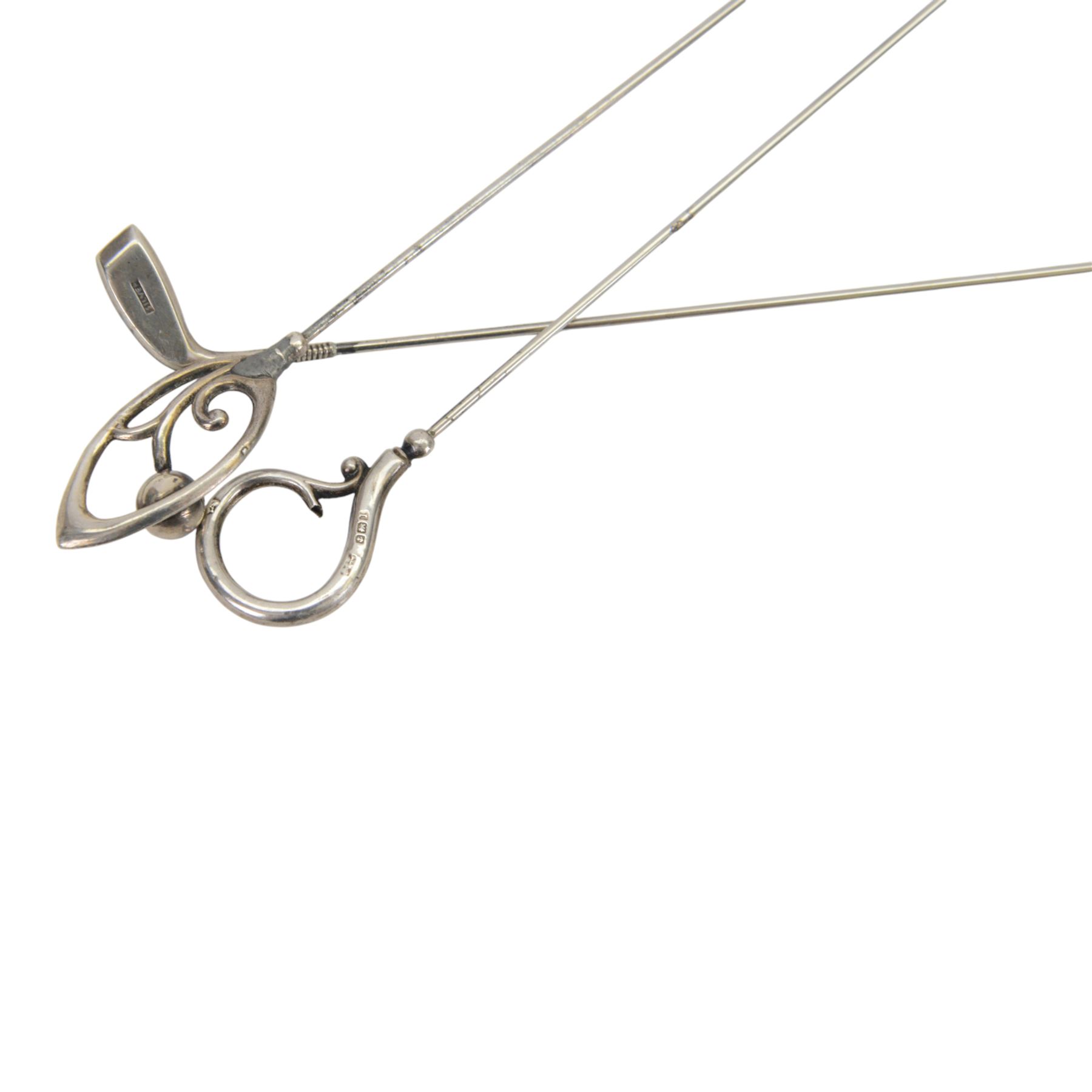 Collection of four silver hatpins including two Charles Horner examples, hallmarked, together with two other hatpins, all within a metal case