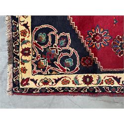 Persian rug, red ground field decorated with stylised flower heads and bird motifs, floral scrolling border