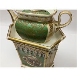 Two 19th century continental teapots and warmers, each teapot upon a hexagonal warming base, the first example painted with landscape scenes, the second with nesting birds in gilt branches, H28cm