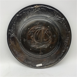 Large copper Arts and Crafts charger, possibly Newlyn, of circular form, repoussé decorated with a galleon to the centre, surrounded by a stylised tendril border, D58cm