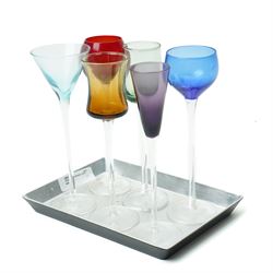   Six cordial glasses each with a different coloured bowl on slender stems understood to be retailed by Harrods on a small lacquered tray