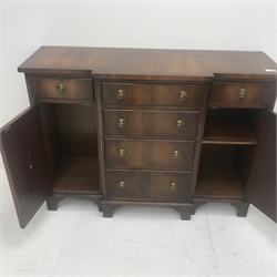 Small reproduction cross banded mahogany breakfront cabinet, two short and four long drawers, two cupboards, shaped bracket supports, W105cm, H77cm, D36cm
