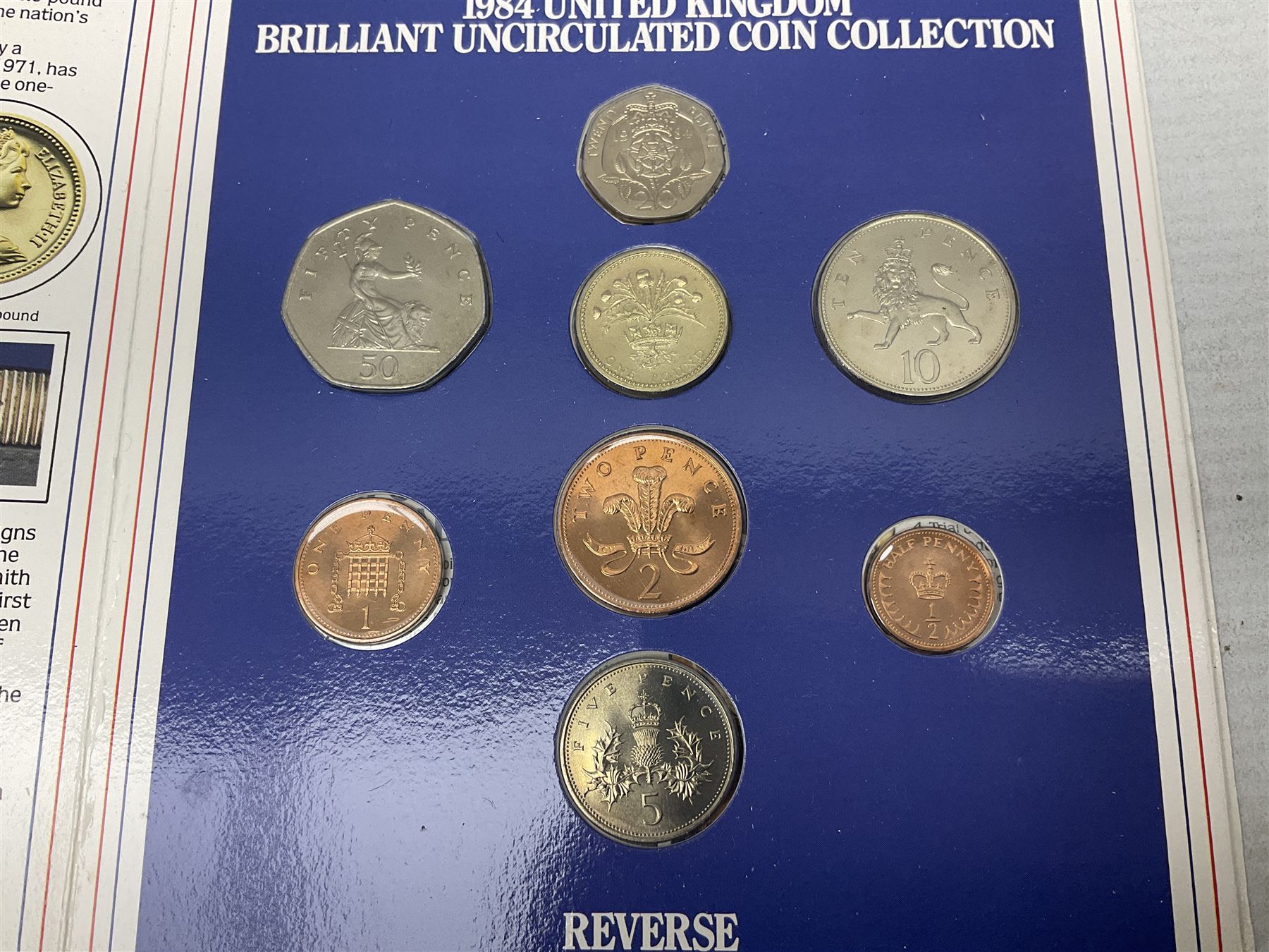 The Royal Mint United Kingdom 1984 brilliant uncirculated coin collection, 1997 and 2001 commemorative crown coins, 1997 old round one pound, all in card folders and four sterling silver medallic first day covers from the 'Great Britons' collection housed in a blue folder