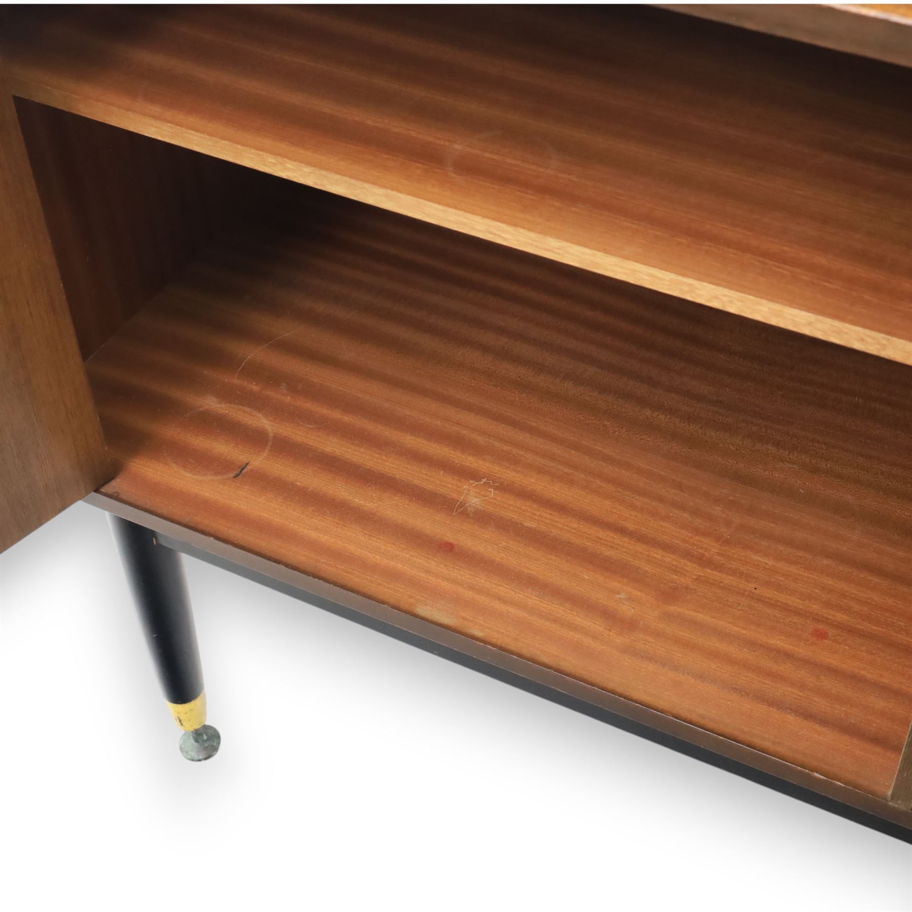 G Plan - ‘Librenza’ tola wood sideboard, the rectangular top above two cupboards to either side and three graduated central drawers, the drawer and door fronts veneered in figured tola wood with brass handles, standing on splayed tapering legs