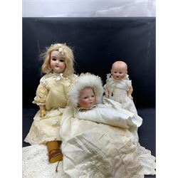 Two German bisque head dolls, to include a Franz Schmidt example with blue glass eyes and an Armand Marseille 590 example with applied hair, together with a Schoenau & Hoffmeister bisque doll's head, pair of doll's hands and a collection of clothing