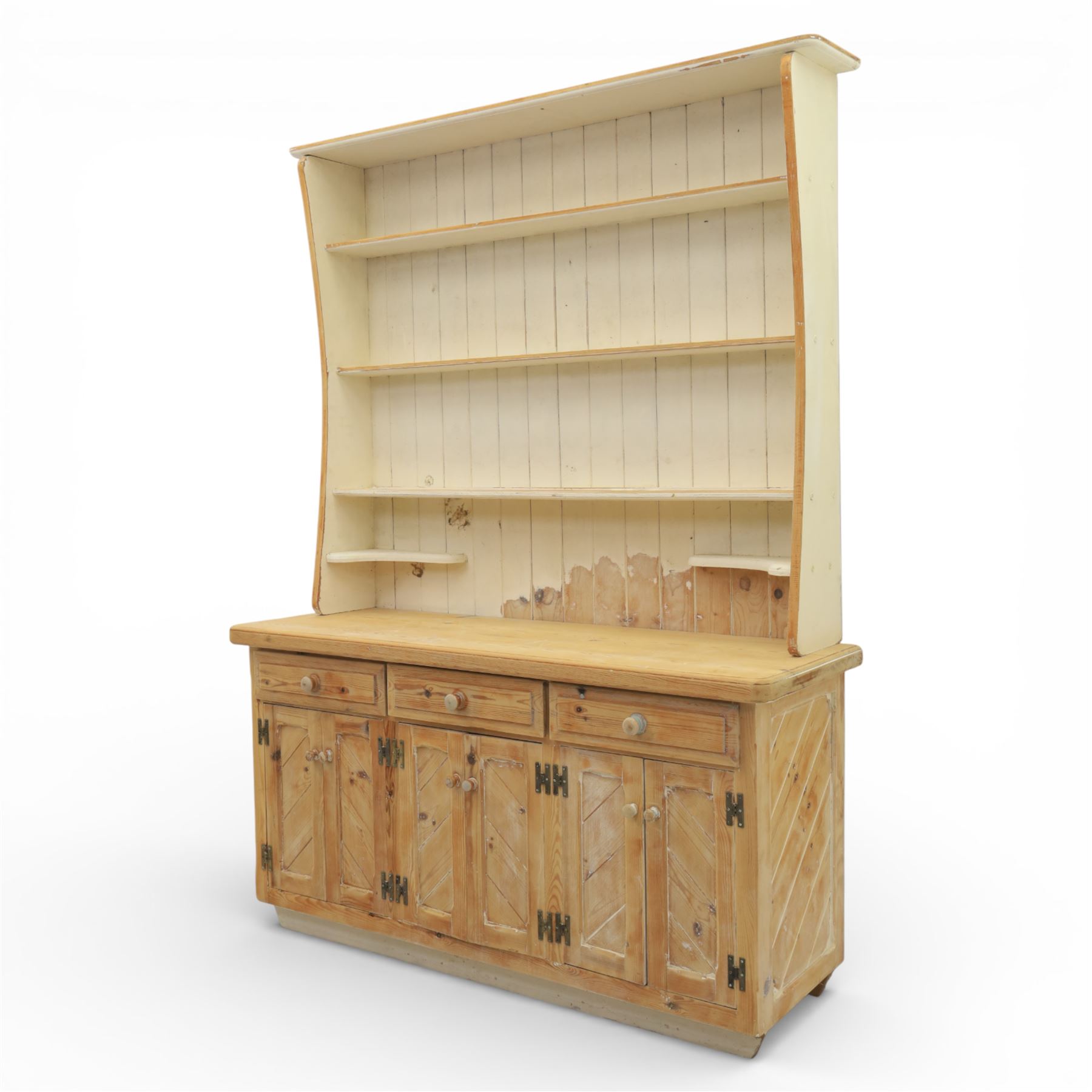 Late 20th century pine and white painted dresser, the upper section with three shelves and boarded back, upon a base with three drawers with knob handles and three panelled cupboard doors, on a raised sled base