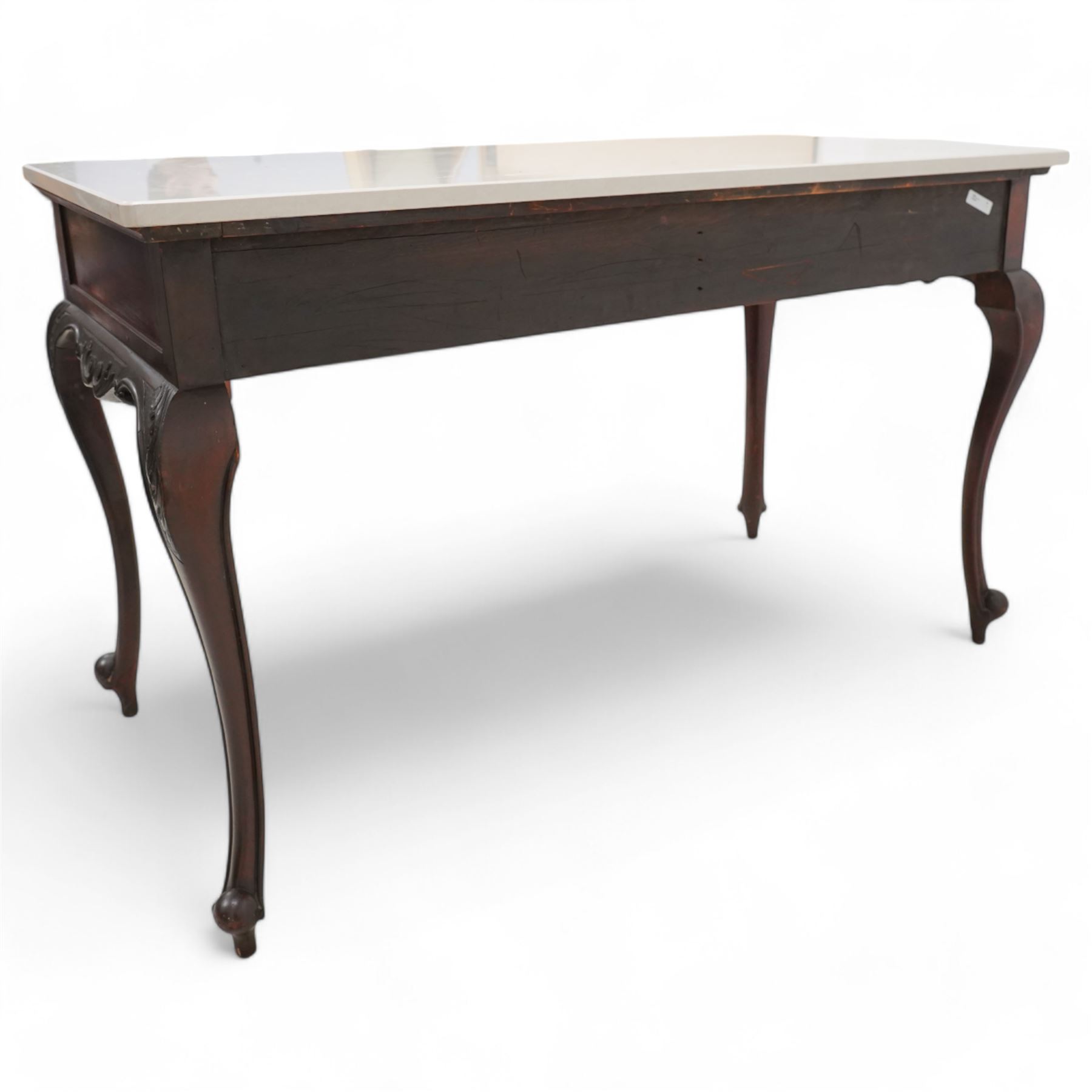 Late Victorian mahogany washstand, rectangular pale granite top over two drawers, the drawer front decorated with blind fretwork and ornate gilt cast metal handles, shaped apron carved with curled foliage, on acanthus carved cabriole supports 