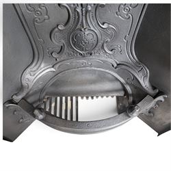 Victorian cast iron fireplace, the arched surround cast with scrolling foliate ornament and central shield-shaped cartouche, fitted with a bowed fire basket, in black painted finish