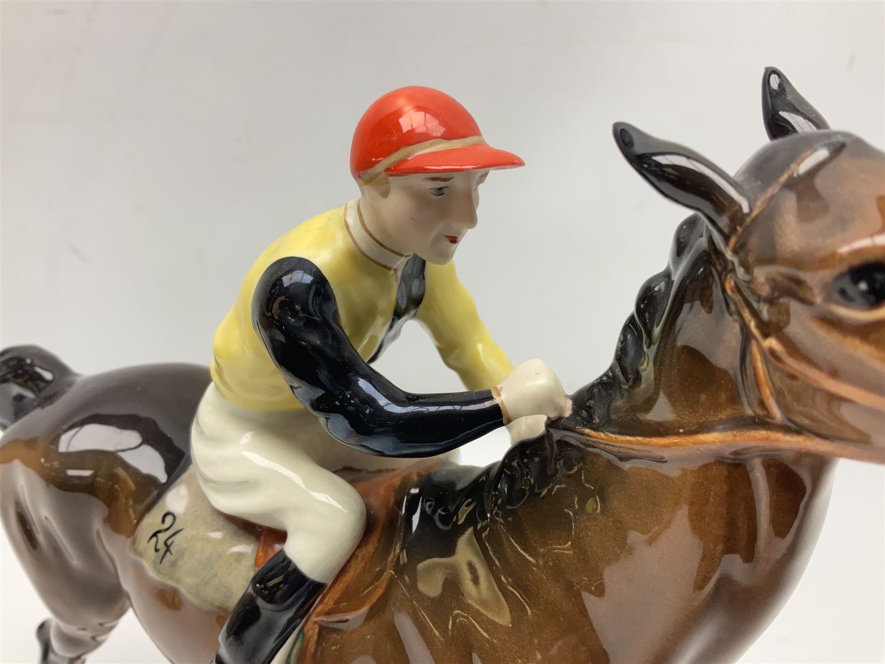 Beswick jockey on walking horse no 1037, in black white and yellow jockey colours, with printed mark beneath, H22cm