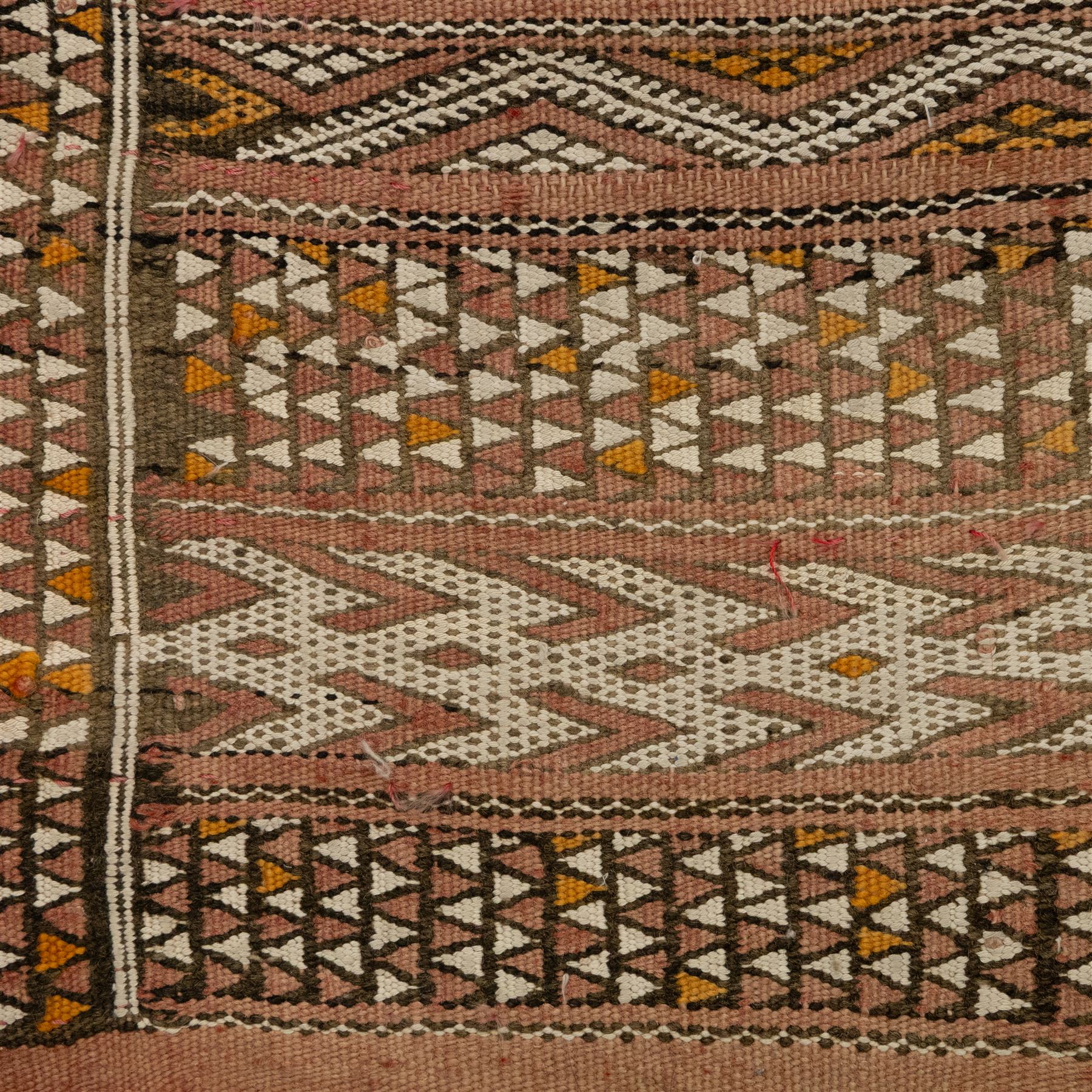 Berber style mid 20th century flat-weave kilim, woven is alternating horizontal bands of hooked lozenges, diamonds, and chevron motifs in a terracotta, ochre, ivory, and brown palette, framed by narrow geometric borders  