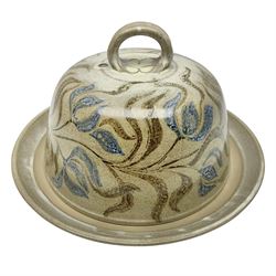 John Egerton (c1945-): studio pottery stoneware, cheese dish and cover, decorated with flowering sprigs on a cream ground, H20cm D35cm