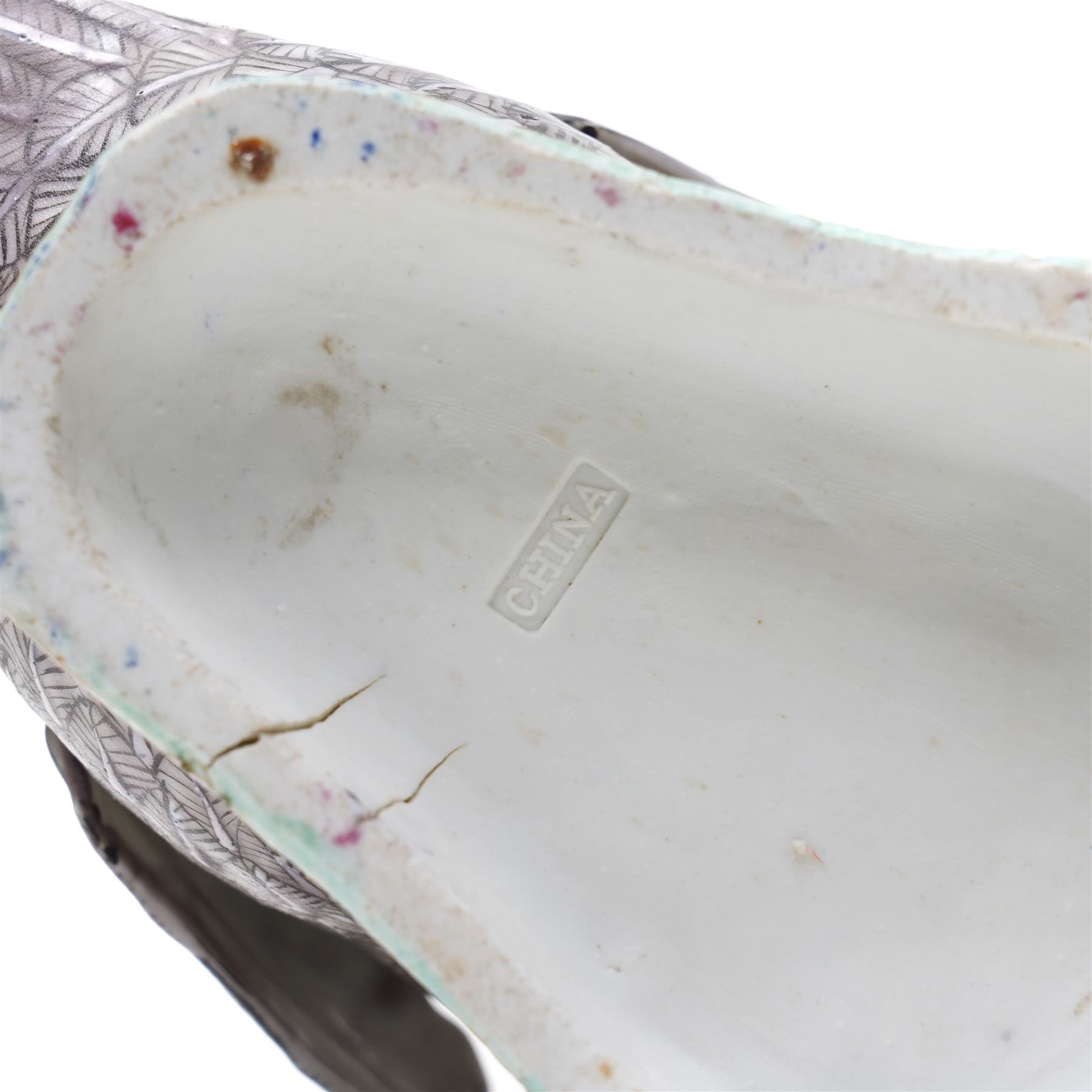 Pair of 20th century Chinese Export porcelain ducks, each naturalistically modelled with aubergine and white enamel plumage and seated on polychrome rockwork bases, H24cm 