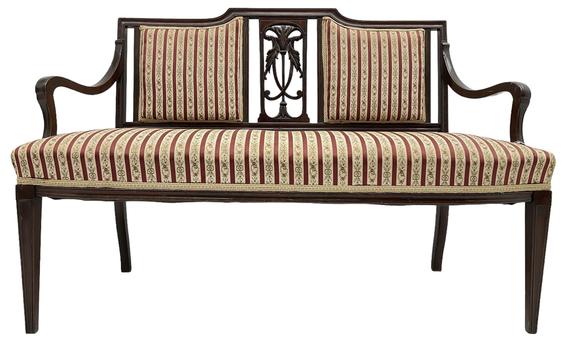 Edwardian mahogany framed three-piece salon suite - two-seat sofa, stepped cresting rail over acanthus and scroll carved pierced splat, upholstered in striped fabric (W124cm, H87cm, D62cm); and a pair of matching armchairs (W60cm) 