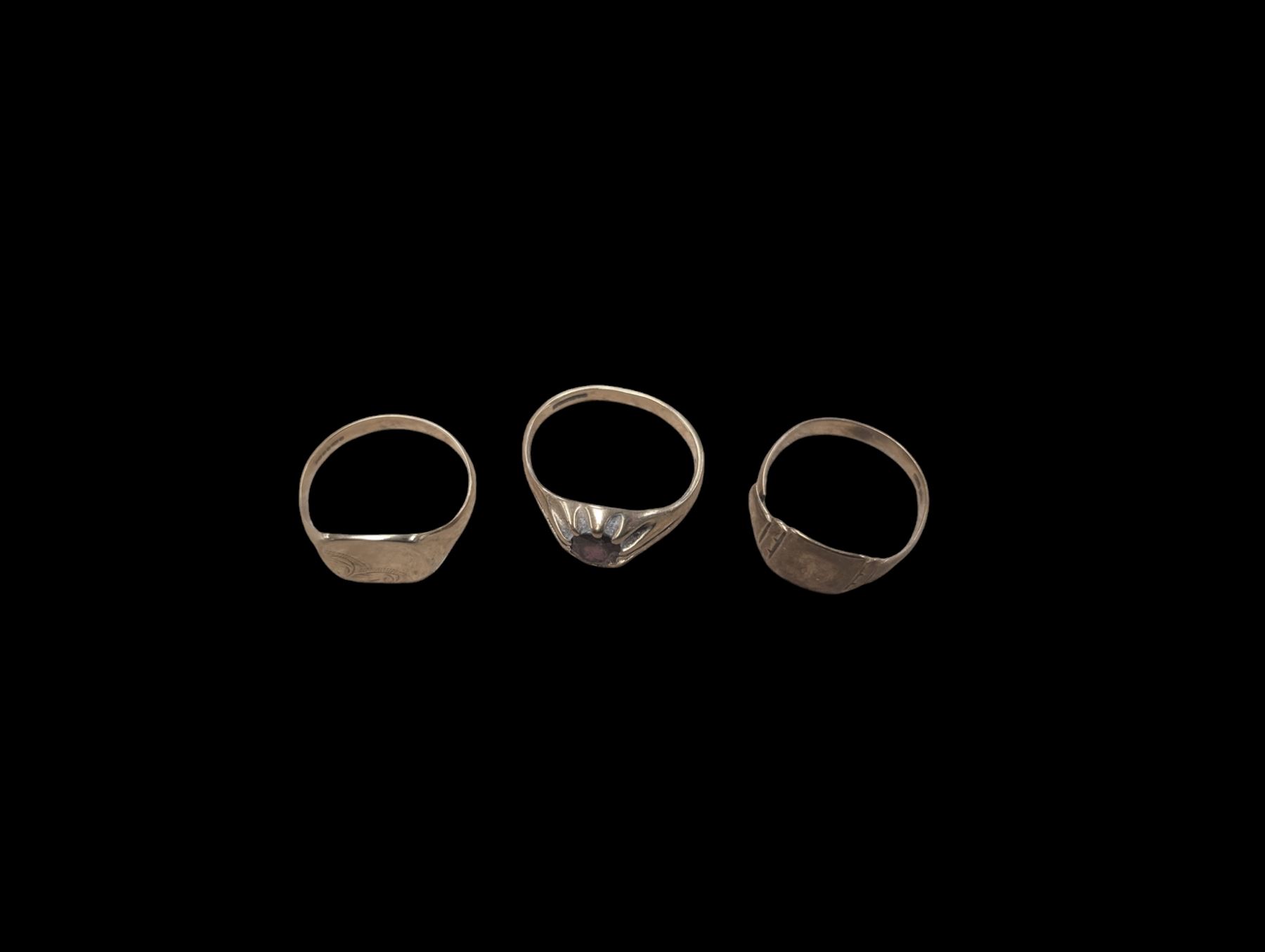 Three 9ct gold rings, comprising two signet rings and a stone set signet ring, all stamped or hallmarked 