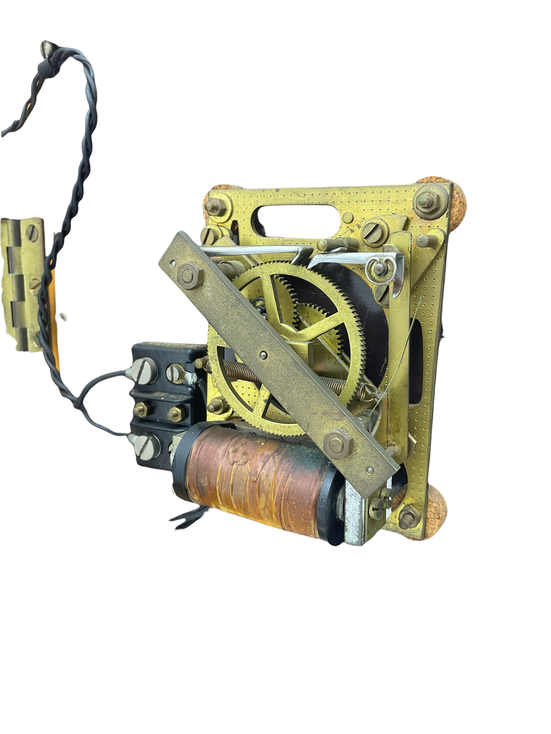 A mid-20th century Gent of Leicester(Blick Electric) Pulsynetic Master Clock in a full length glazed wooden case, with a square white dial with Arabic numerals, minute markers and baton hands, with pendulum and a record card dating from the 1970’s. 
This master clock would have been wired to send time signals to other slave dials in a large building, frequently used in hospitals, schools and factories during the 20th century
With a second electrical movement housed in a glazed square cabinet.


