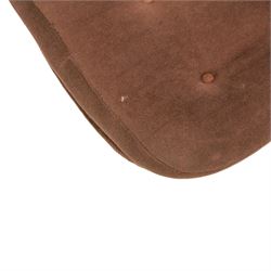 Pair of mid 20th century brown velvet swivel lounge chairs and matching footstool, the shaped and padded back with buttoned segmented cushion over conforming seat cushion, flared armrests and moulded sides, raised on a five point metal swivel base, the footstool en suite with buttoned cushion and matching metal base