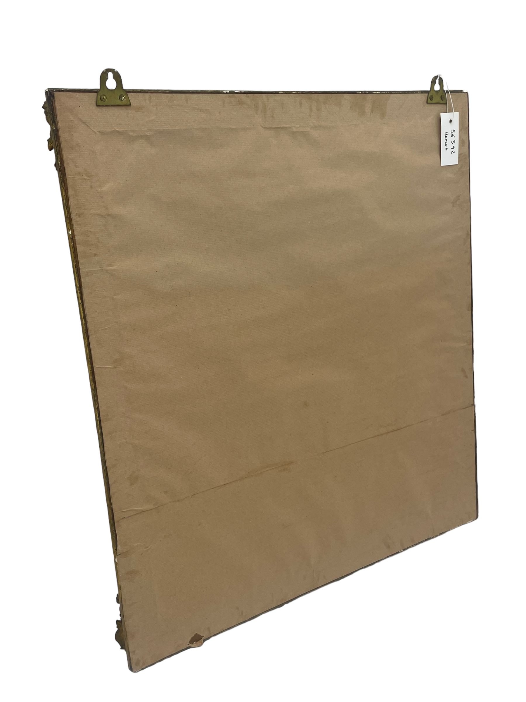 19th century gilt framed wall mirror, the corners decorated with flower heads with extending foliage, plain mirror plate