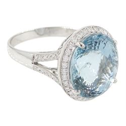 18ct white gold aquamarine and diamond cluster ring, single oval cut aquamarine of approx 8.20 carat, surrounded by milgrain set round brilliant cut diamonds, with diamond gallery and split diamond set shoulders, stamped 750, total diamond weight approx 0.30 carat