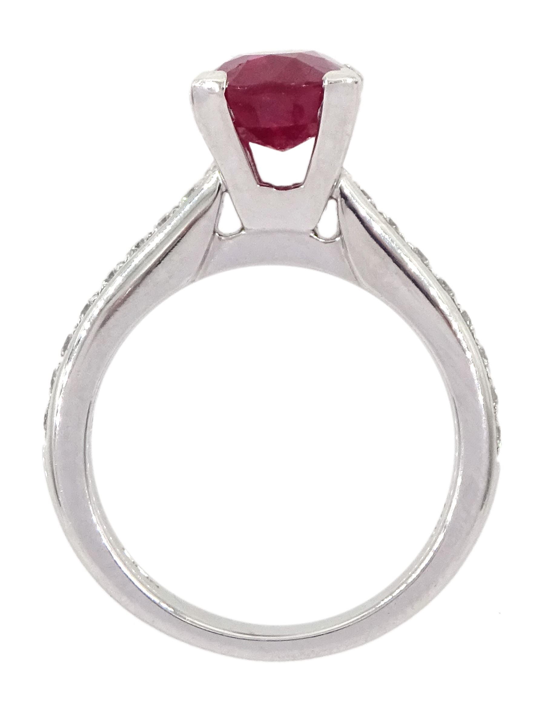 18ct white gold ruby and diamond ring, single oval cut ruby of approx 2.75 carat, with channel set diamond shoulders, hallmarked