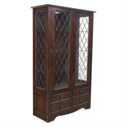 Early 20th century oak display cabinet, the moulded rectangular cornice above a pair of le...